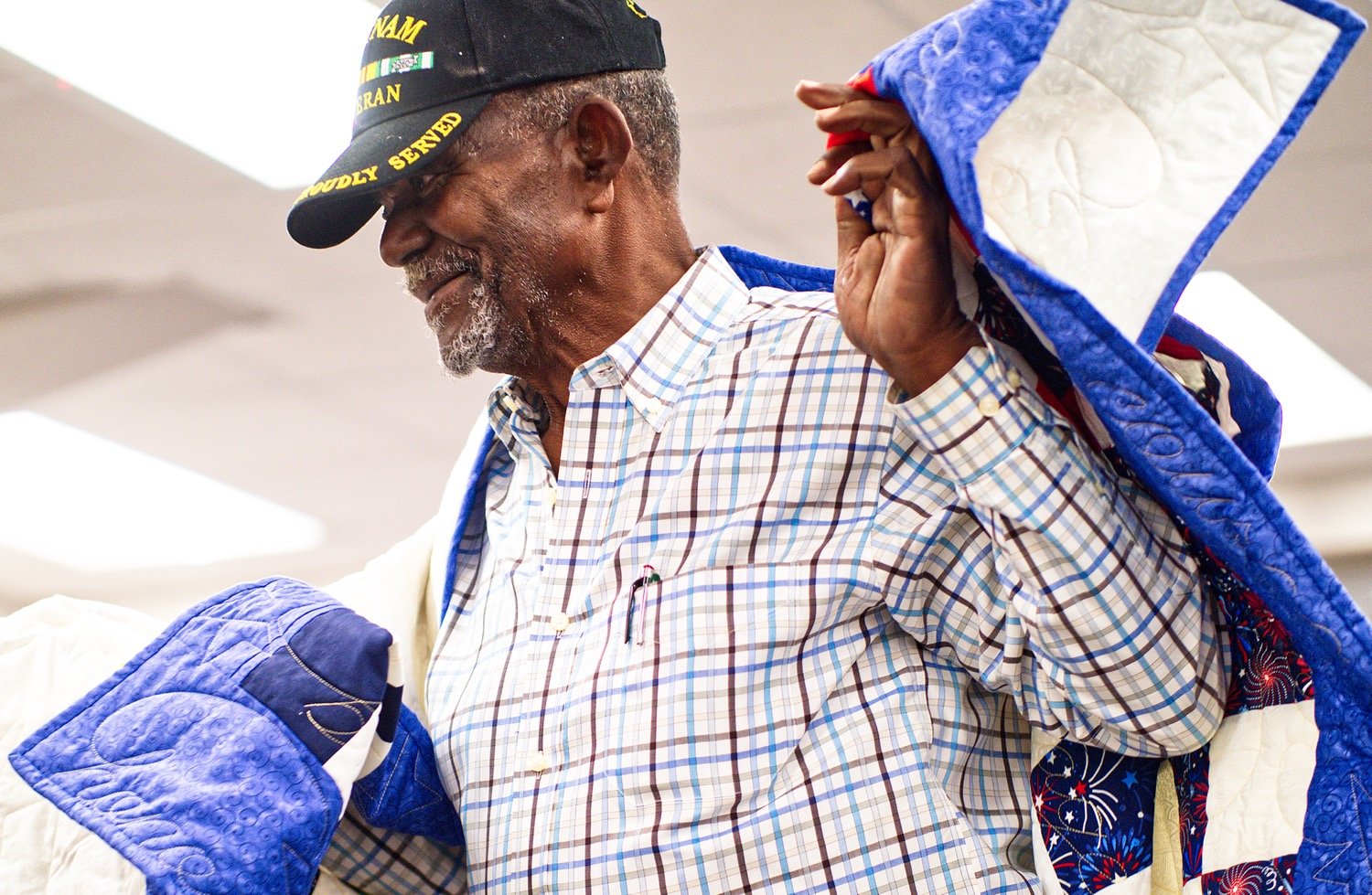 Rev. Ray Williams, a U.S. Navy veteran of Vietnam, carries his new quilt. [view more veteran appreciation]